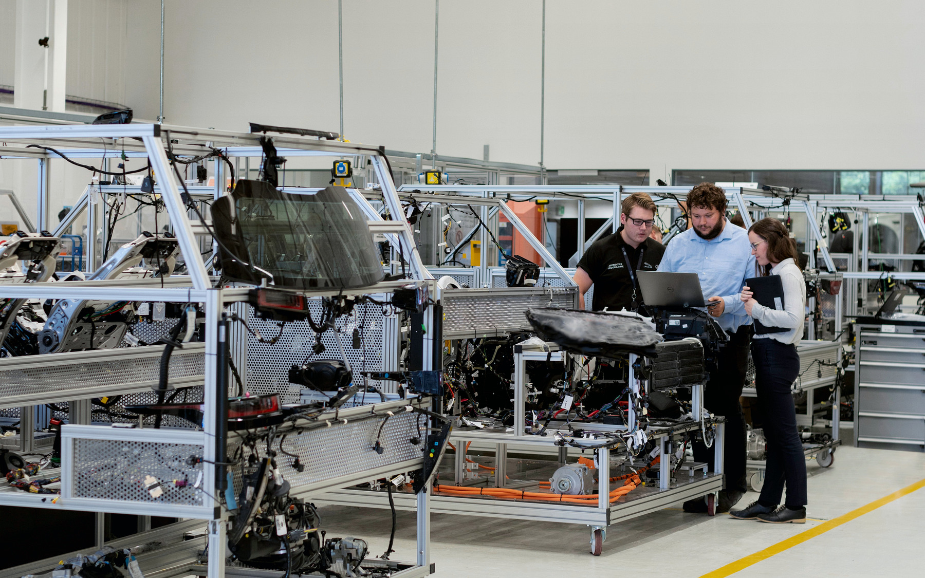 Photograph of engineers reviewing equipment in a manufacturing workshop